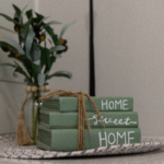 Decorative stack of books with Home Sweet Home text used for real estate staging in a Grand Haven home