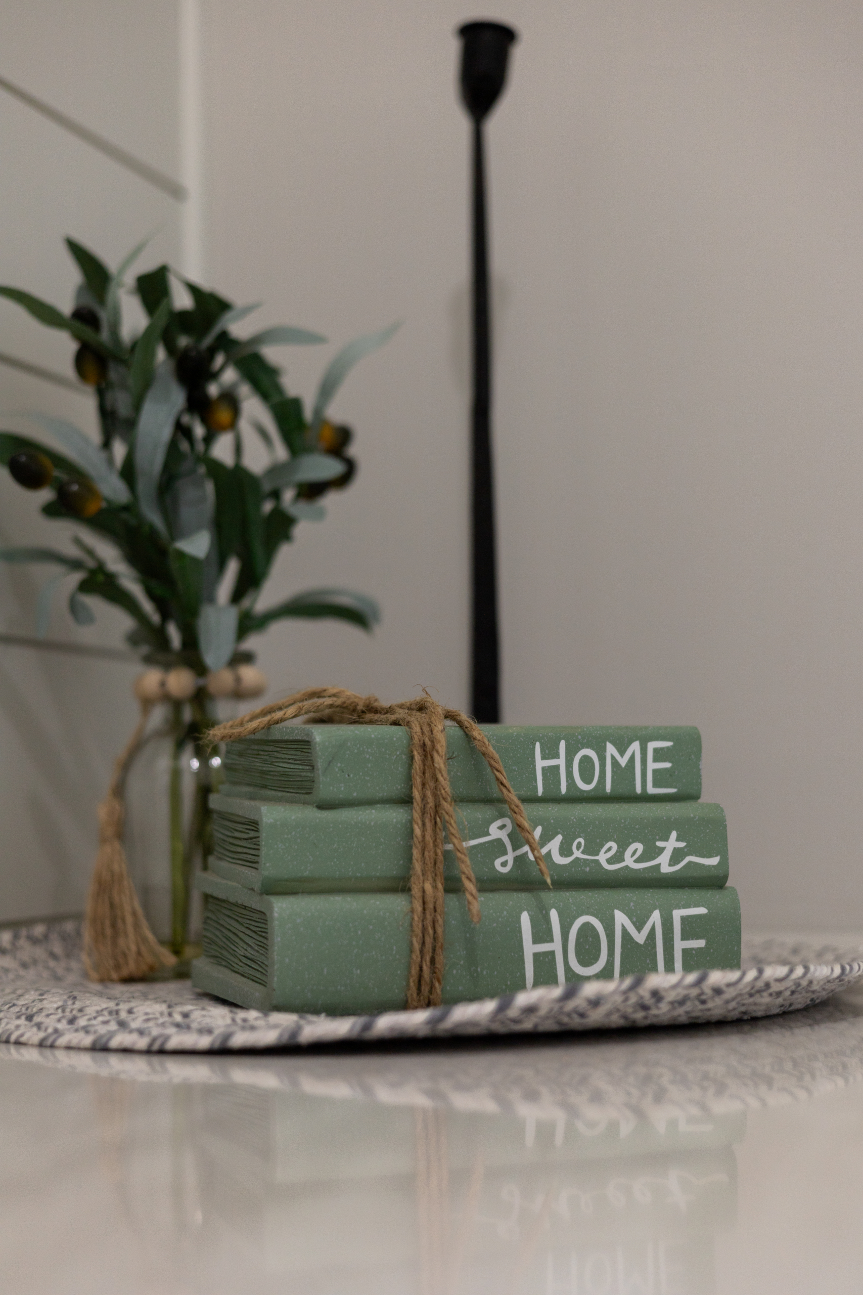 Decorative stack of books with Home Sweet Home text used for real estate staging in a Grand Haven home