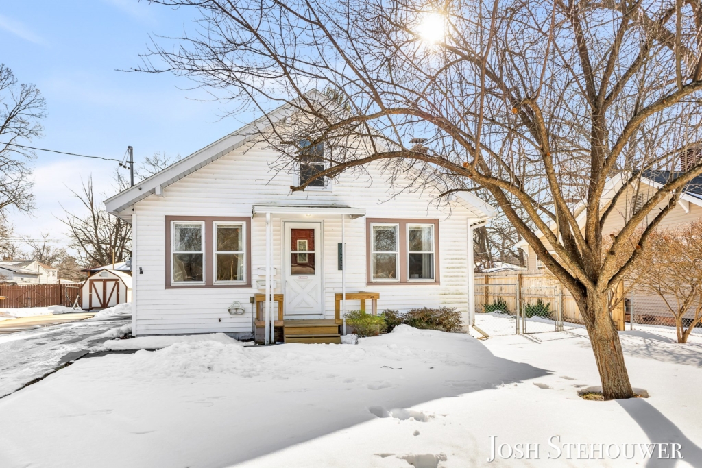 Grand Haven home exterior covered in winter snow with sunlight
