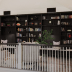 Stylish Grand Haven home interior with black built-in library shelves and seating area