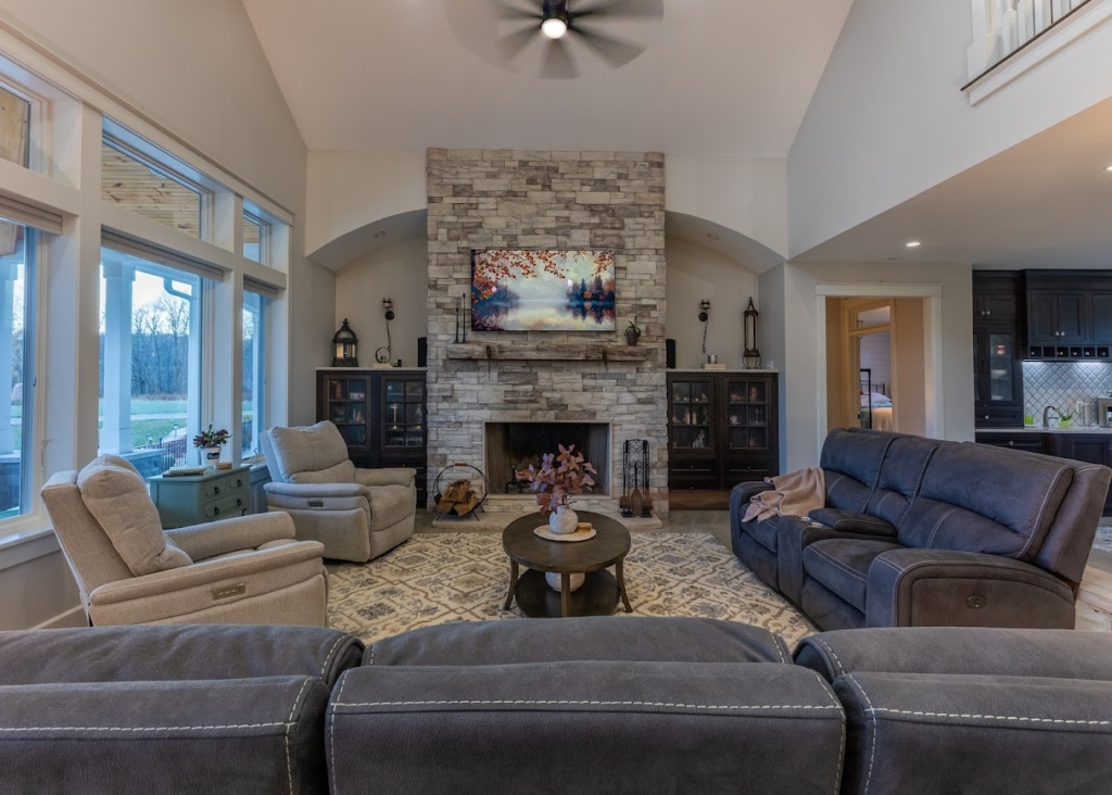 Spacious living room with stone fireplace in a Holland, Michigan lake home.