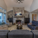 Spacious living room with stone fireplace in a Holland, Michigan lake home.