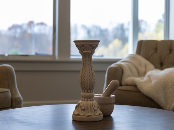 Close-up of soft blanket and warm interior tones inside a Holland, MI lake home.