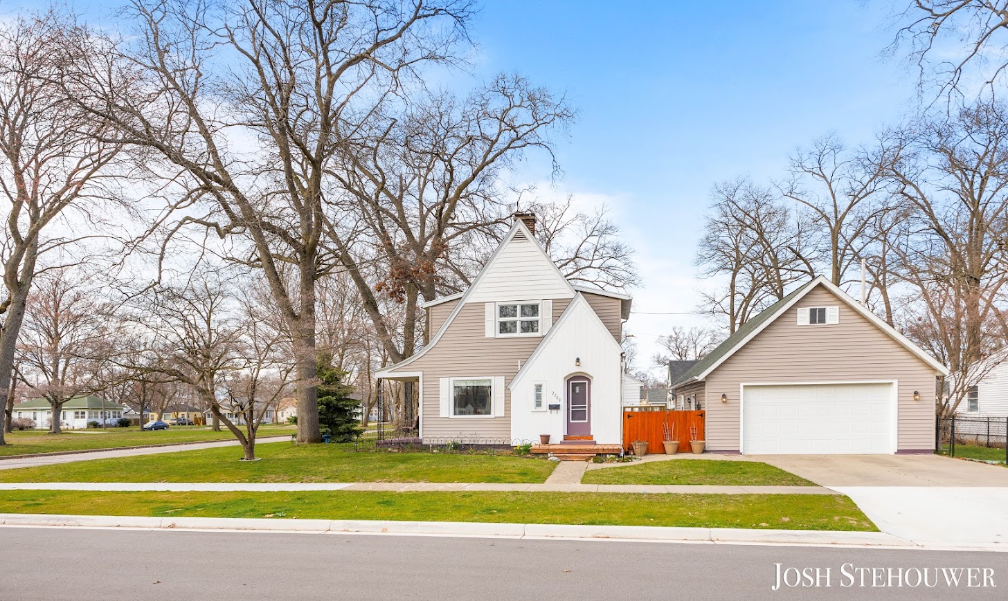 Charming single-family home in West Michigan neighborhood with trees and lawn