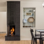 Cozy fireplace and dining area inside a West Michigan Lakeshore home in winter