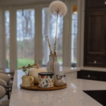 Kitchen island with warm seasonal decor inside a West Michigan Lakeshore home