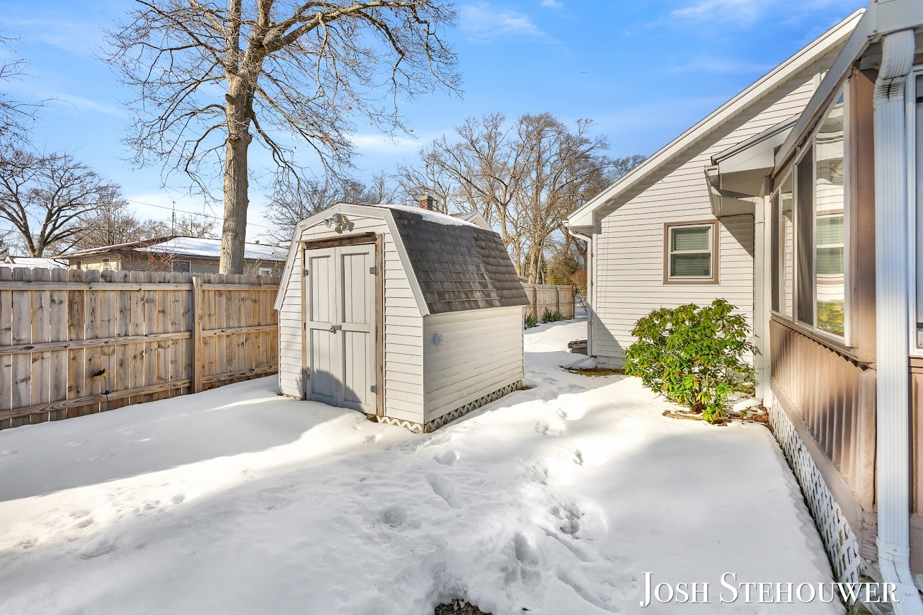 Backyard of a West Michigan Lakeshore home with shed and snow in winter