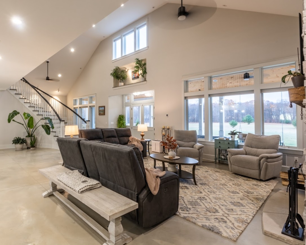 Spacious living room in a West Michigan Lakeshore home with large windows and winter views