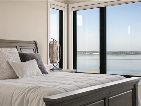 Bright guest bedroom with natural light and simple staging in Spring Lake lake view home