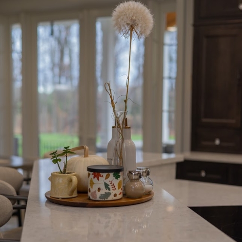 Kitchen island with warm seasonal decor inside a West Michigan Lakeshore home