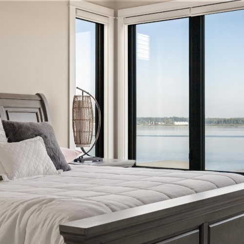 Bright guest bedroom with natural light and simple staging in Spring Lake lake view home