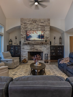 Spacious living room with stone fireplace in a Holland, Michigan lake home.