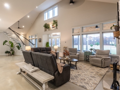 Spacious living room in a West Michigan Lakeshore home with large windows and winter views